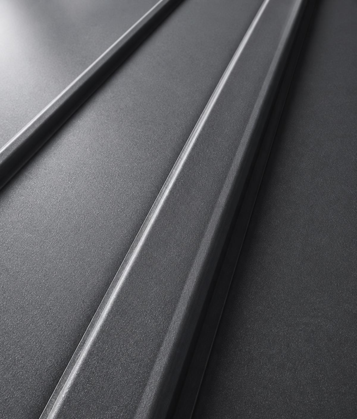 Close-up of dark gray standing seam metal roofing panels